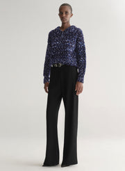 woman wearing blue sweater and black pants