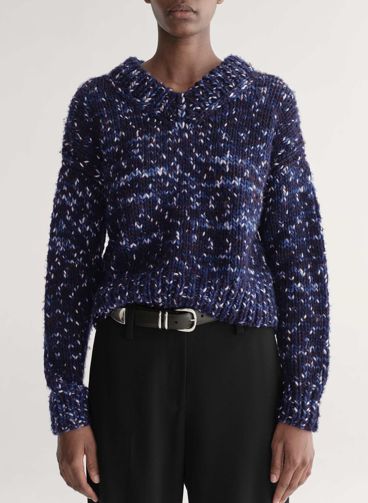 woman wearing blue sweater and black pants