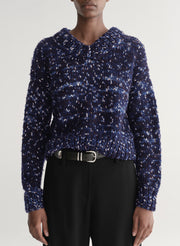 woman wearing blue sweater and black pants