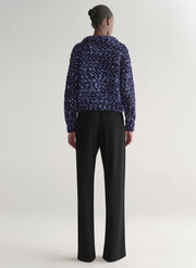 woman wearing blue sweater and black pants