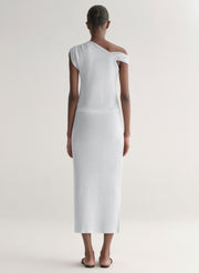 woman wearing silver knit top and matching midi skirt