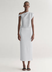 woman wearing silver knit top and matching midi skirt