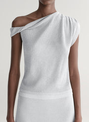 woman wearing silver knit top and matching midi skirt