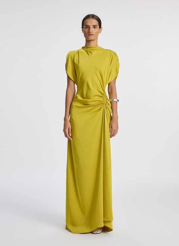 front view of woman wearing yellow satin short sleeve gown