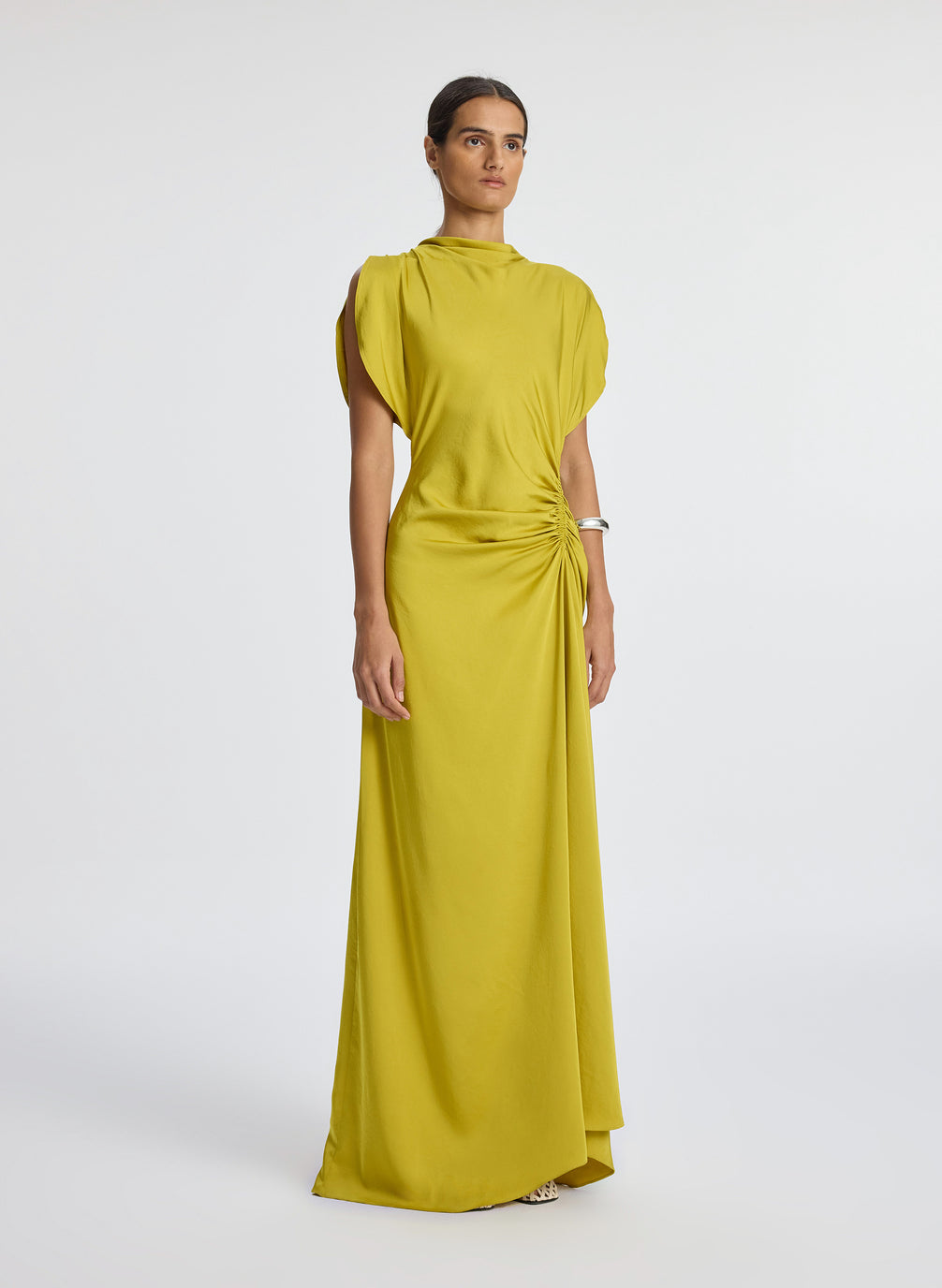 side view of woman wearing yellow satin short sleeve gown
