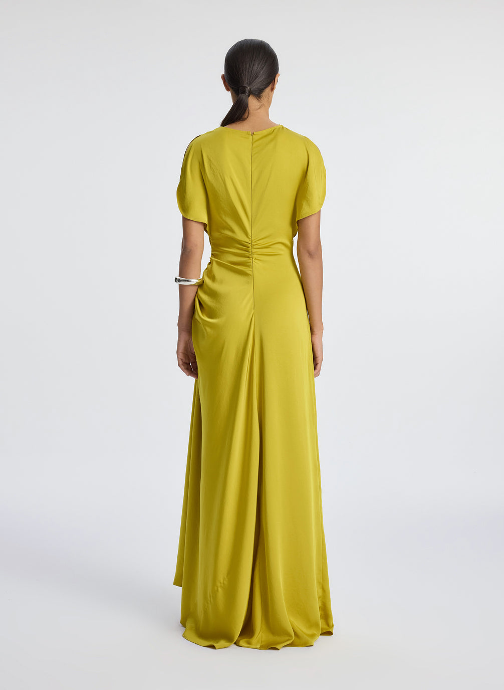 back view of woman wearing yellow satin short sleeve gown