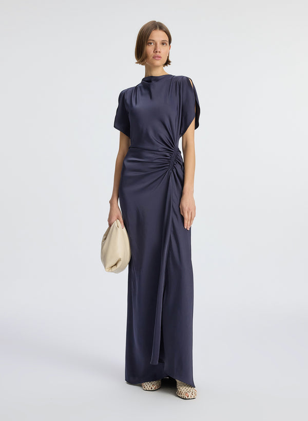 front view of woman wearing navy blue short sleeve satin gown