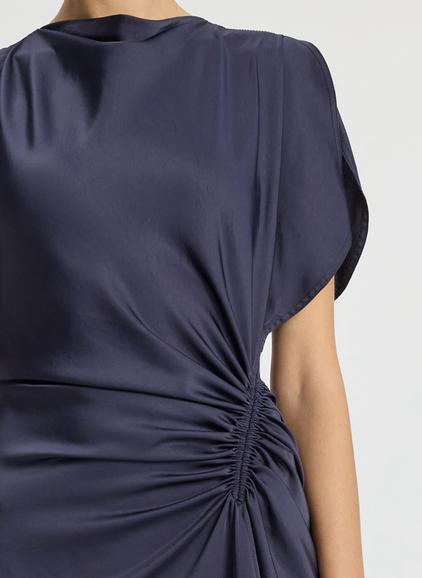 detail view of woman wearing navy blue short sleeve satin gown