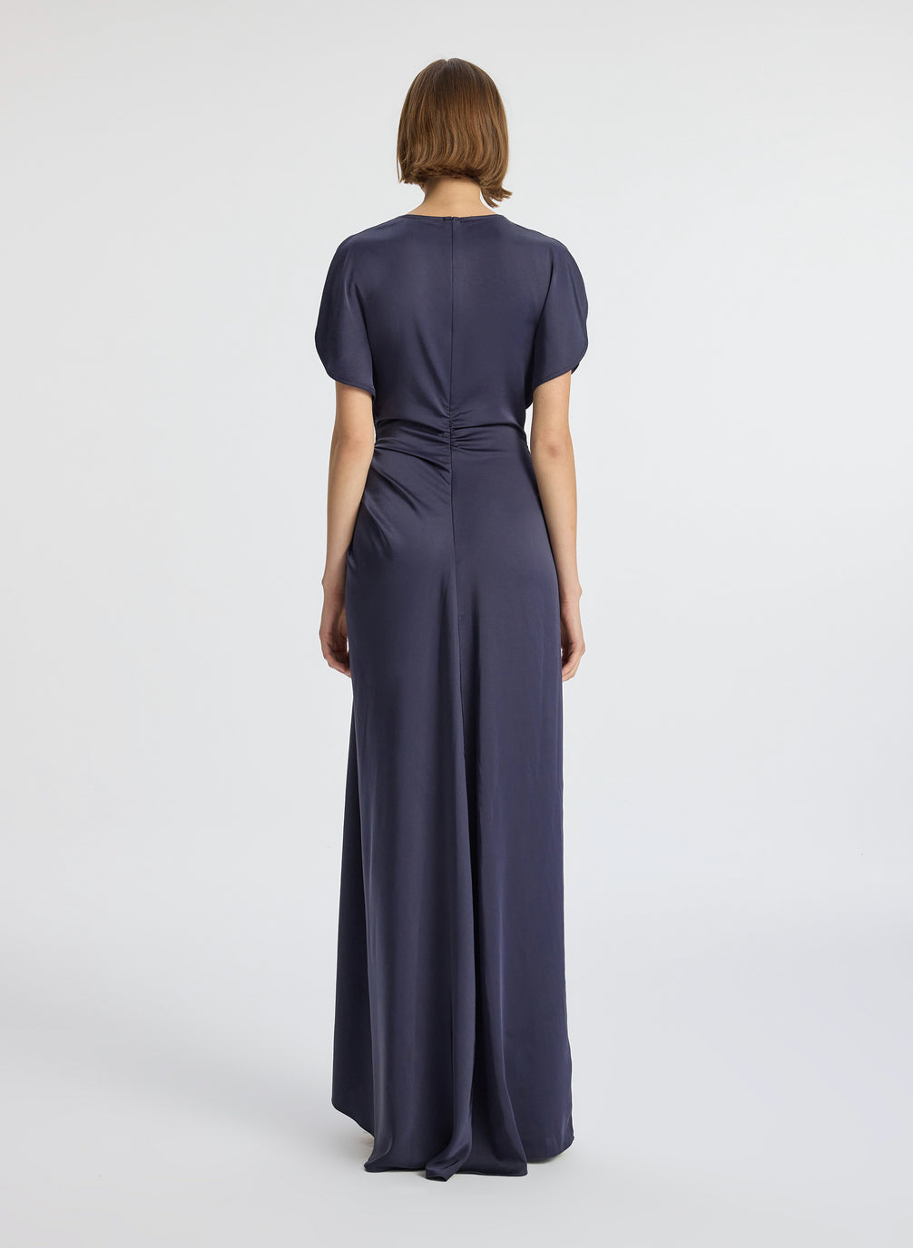 back view of woman wearing navy blue short sleeve satin gown