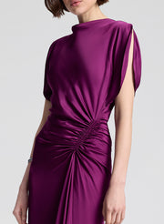 Purple dress with a draped design on a white background