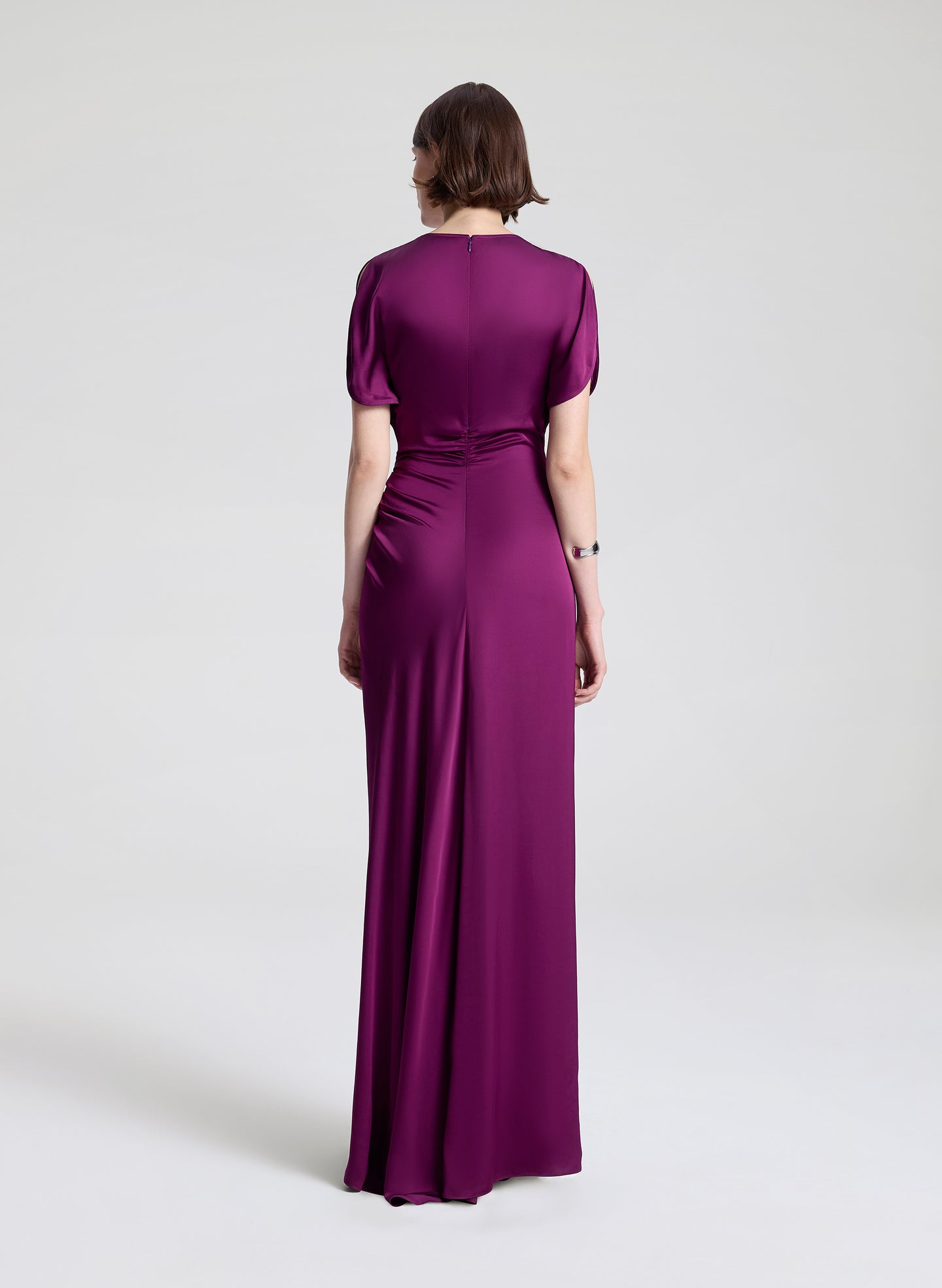 Woman wearing a purple evening gown on a white background