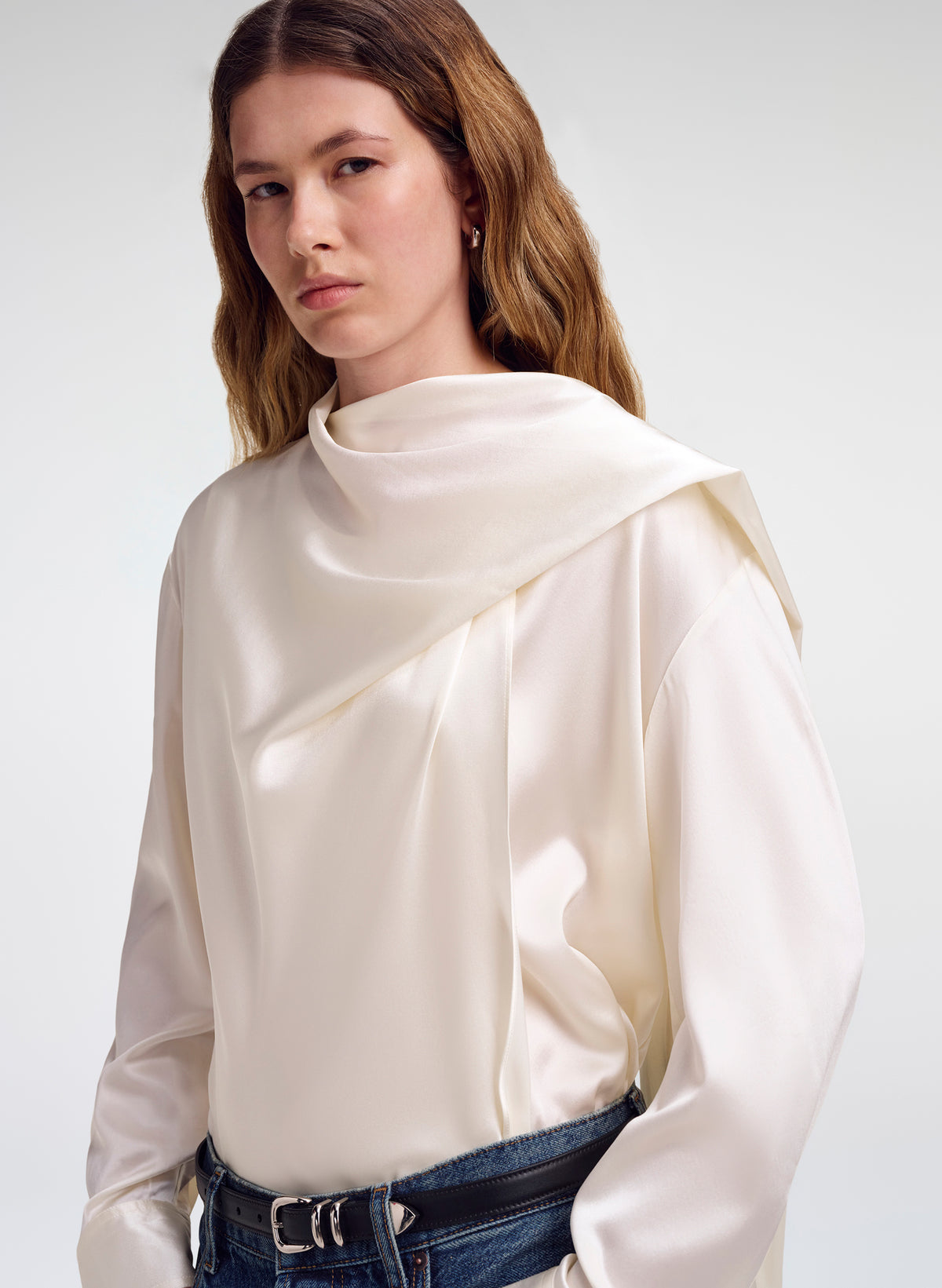 woman wearing draped off white silk top