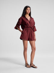 woman wearing burgundy twist front shirt and matching shorts