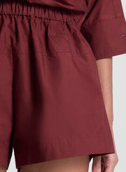woman wearing burgundy cropped shirt and matching shorts