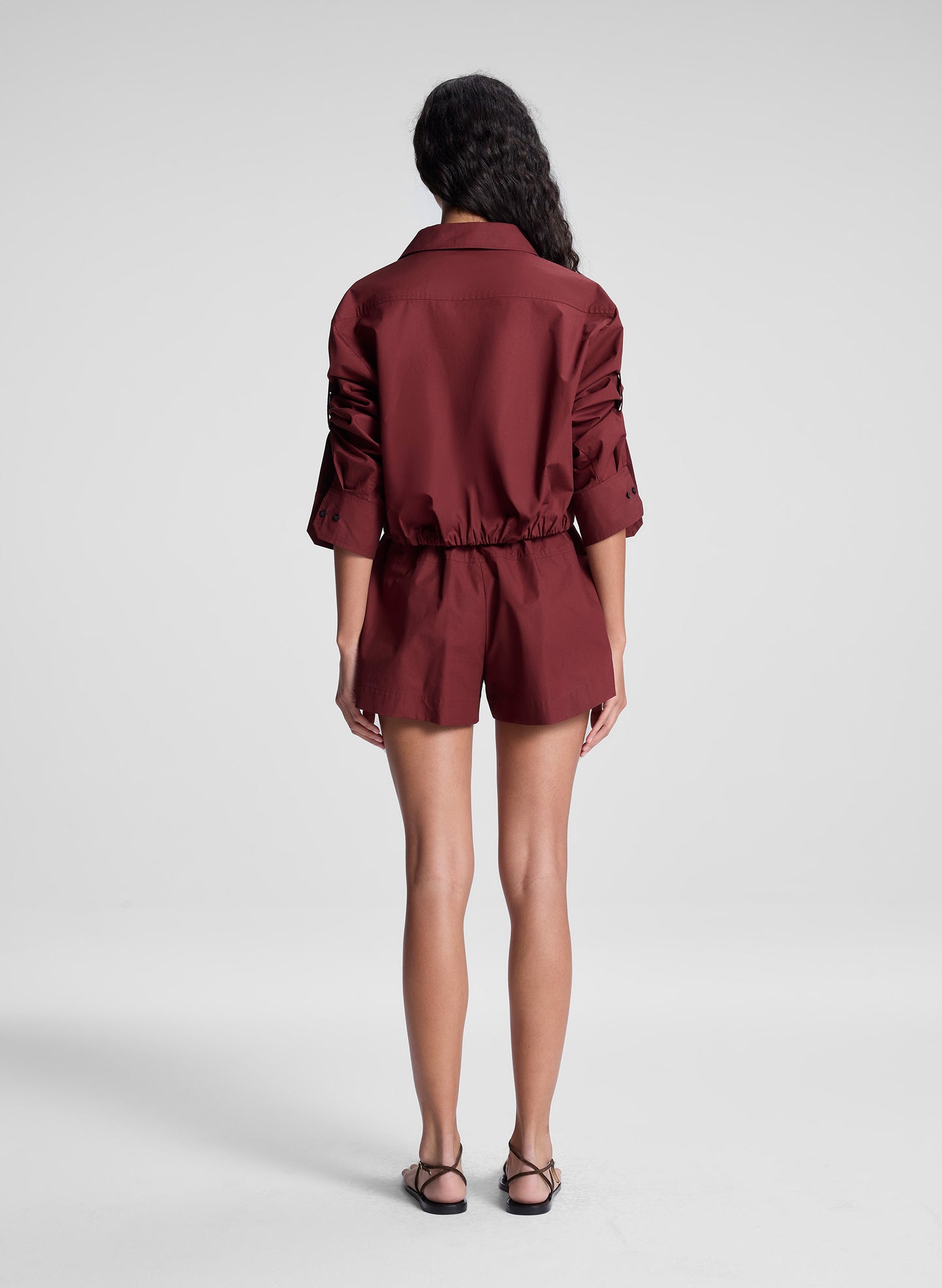 woman wearing burgundy cropped shirt and matching shorts