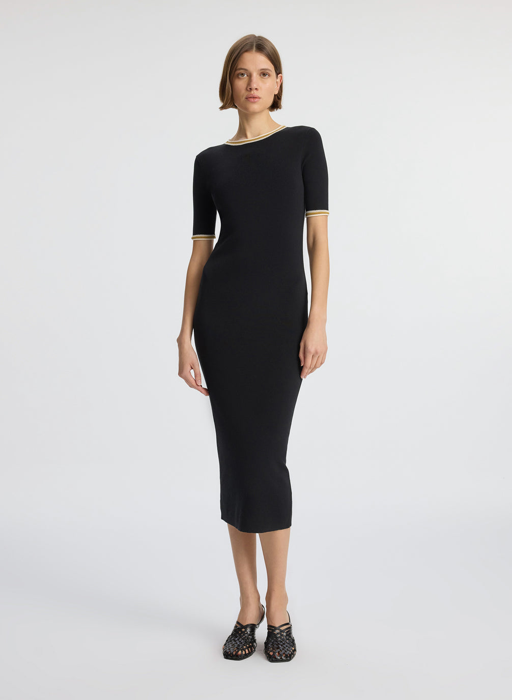 front view of woman wearing black short sleeve midi dress