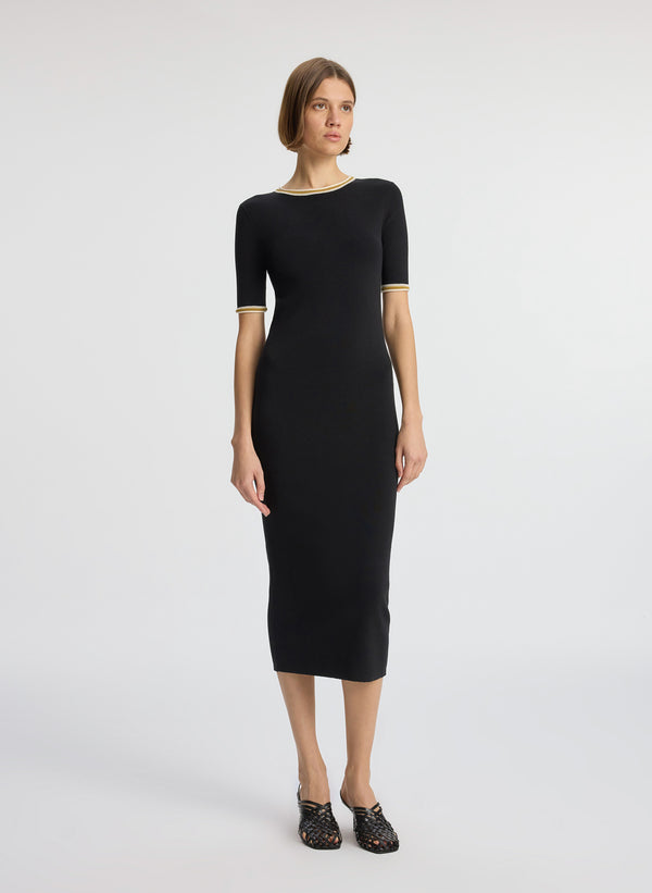 front view of woman wearing black short sleeve midi dress
