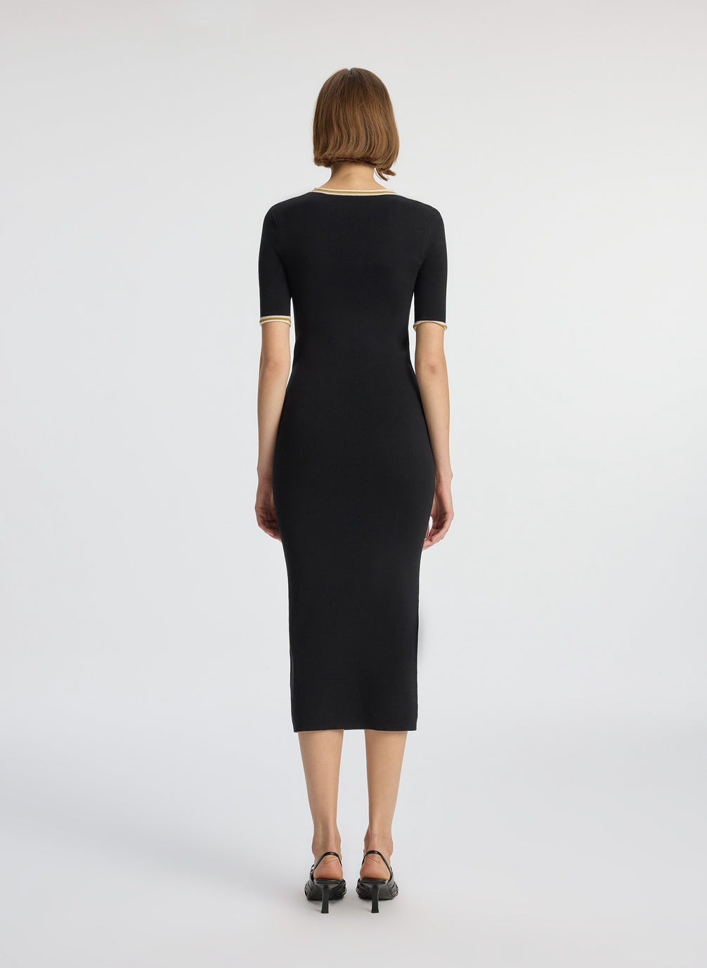 back view of woman wearing black short sleeve midi dress