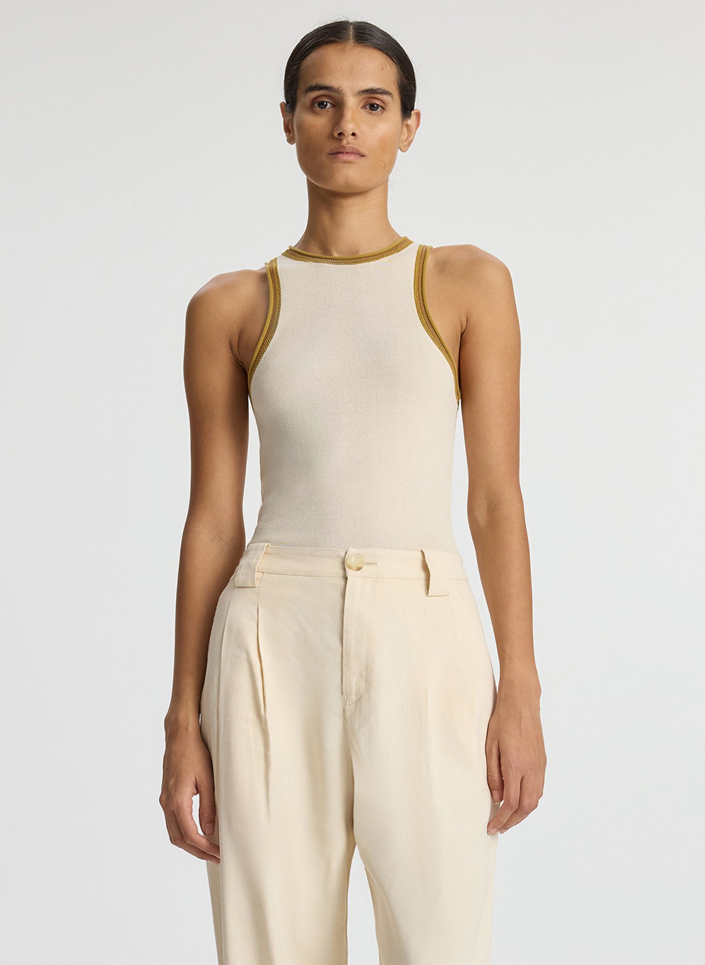 front view of woman wearing cream contrast trim tank and beige wide leg pant