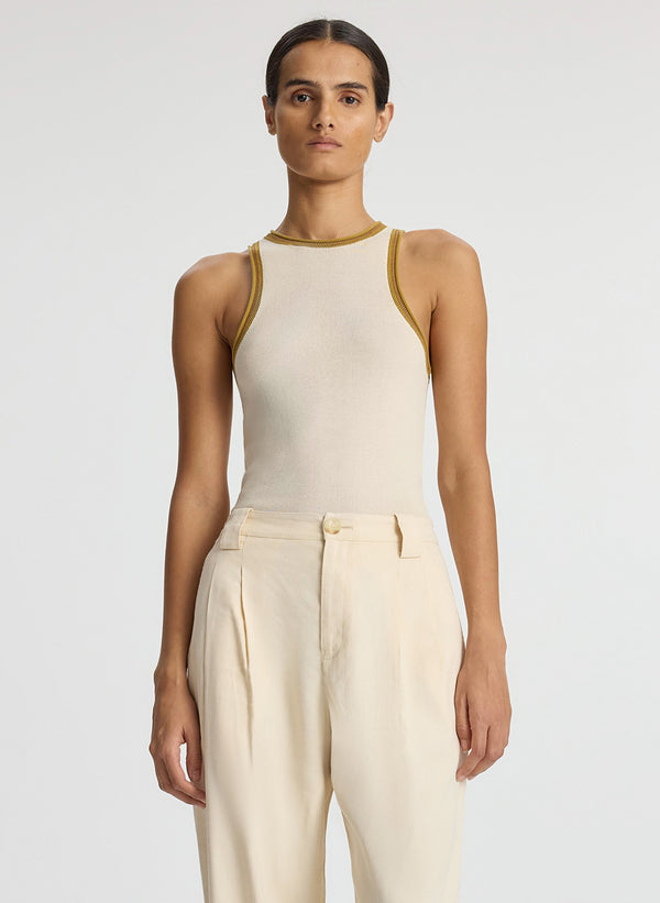 front view of woman wearing cream contrast trim tank and beige wide leg pant