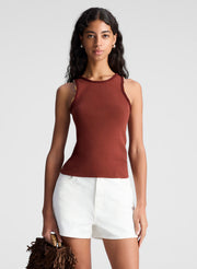 woman wearing brown embellished tank top and beige shorts