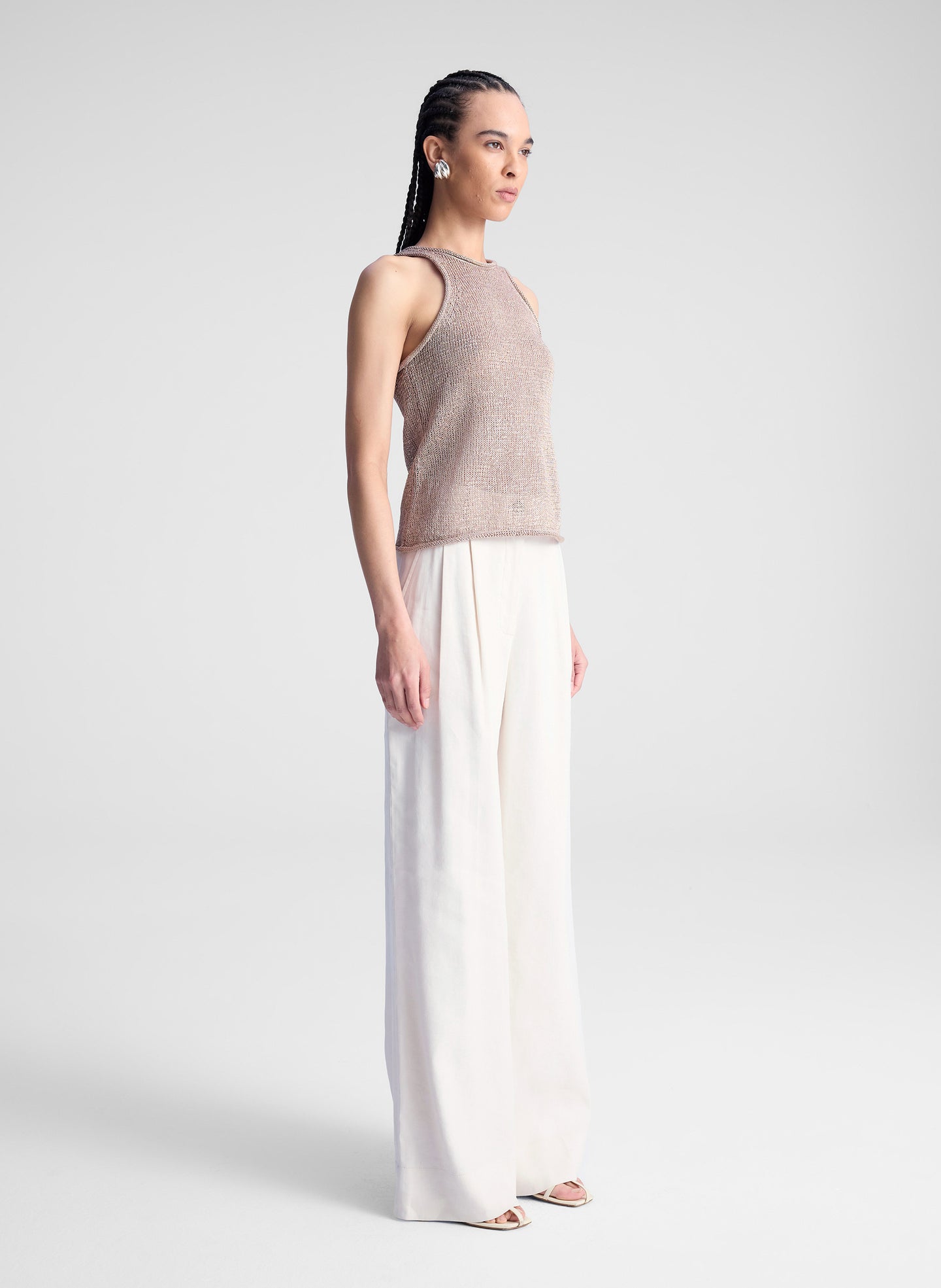 woman wearing beige tank top and beige pants