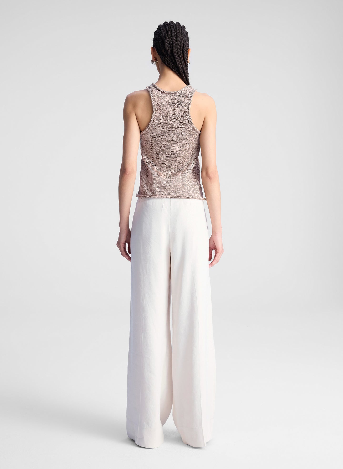 woman wearing beige tank top and beige pants