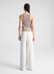 woman wearing beige tank top and beige pants