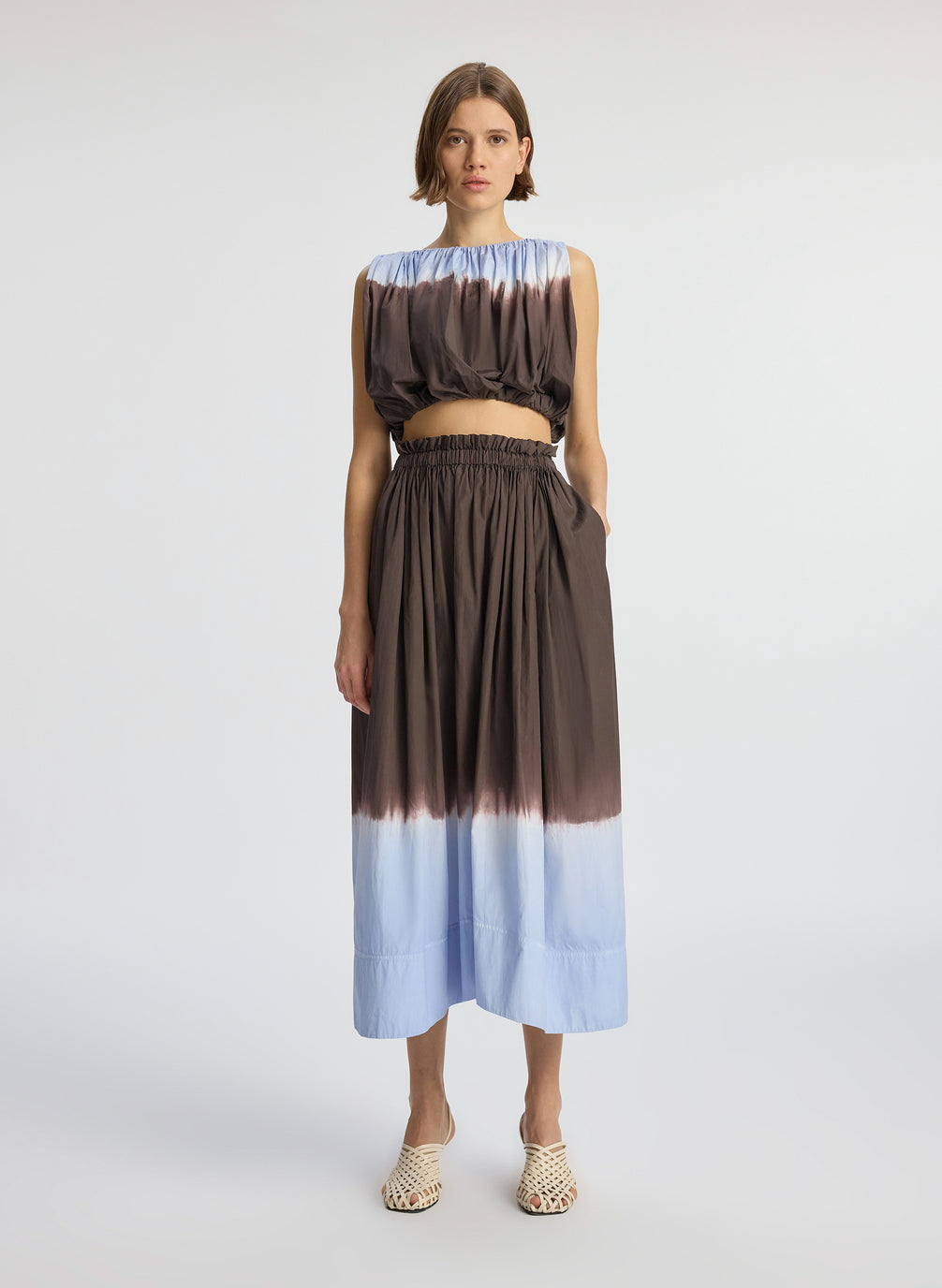front view of woman wearing light blue and brown dip dyed sleeveless top and matching midi skirt