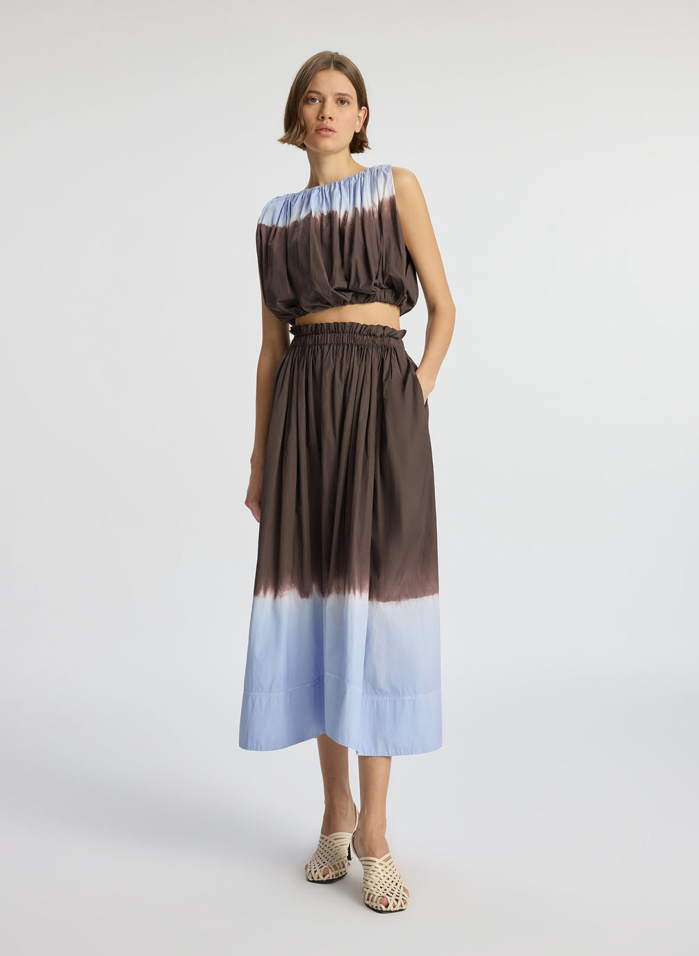 front view of woman wearing light blue and brown dip dyed sleeveless top and matching midi skirt