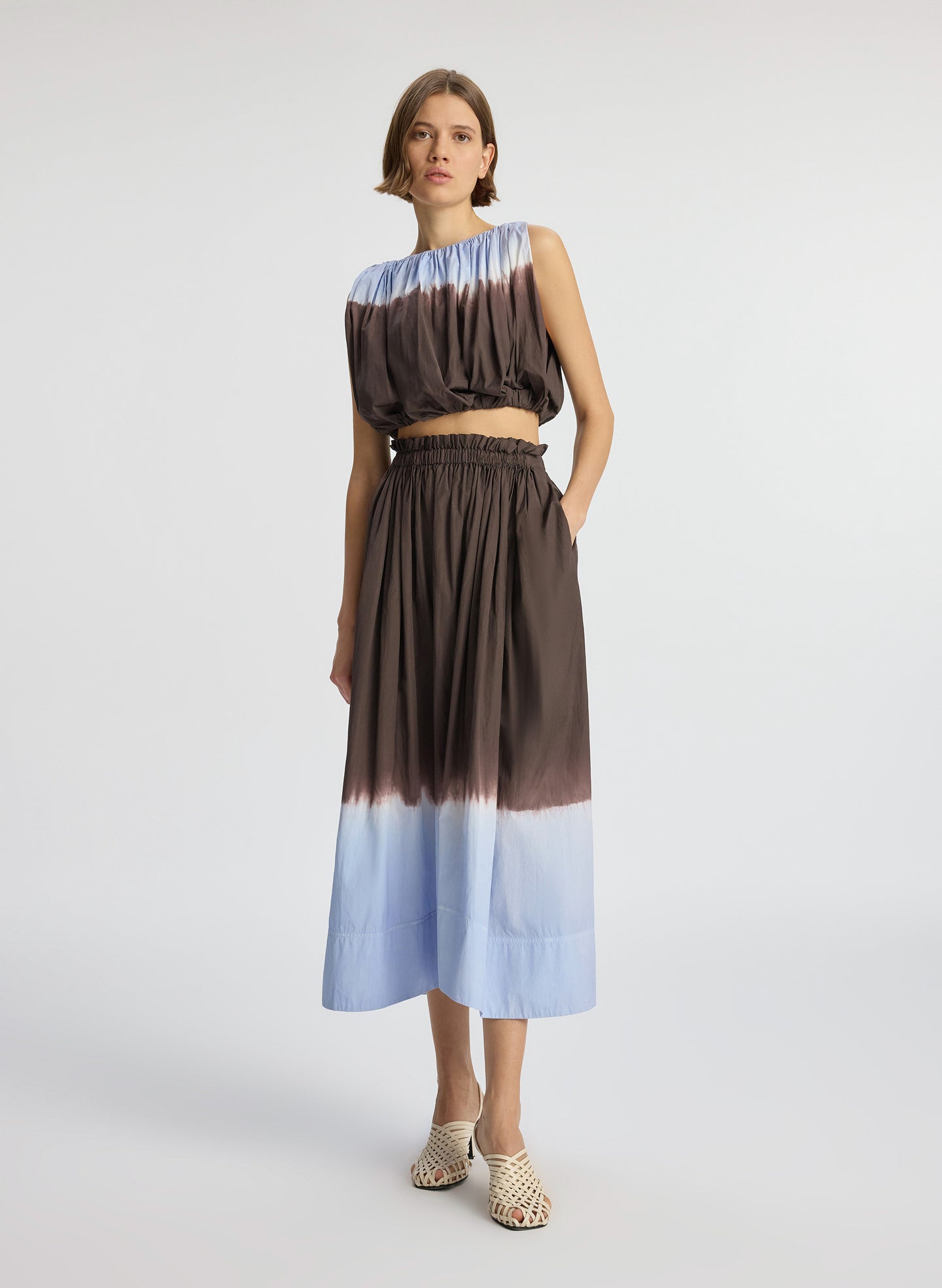 front view of woman wearing brown and light blue dip dye sleeveless top and matching midi skirt