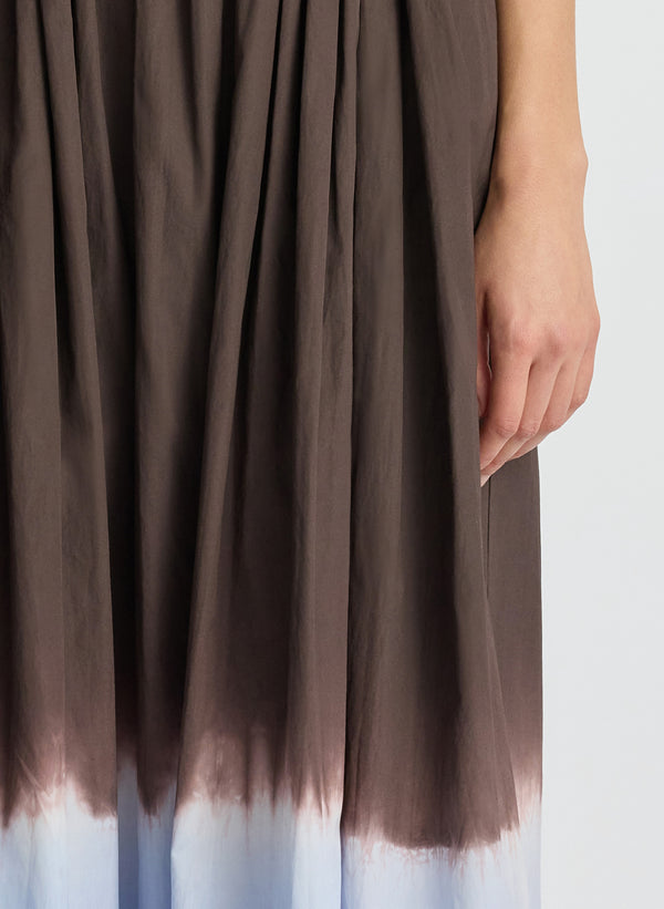 detail view of woman wearing brown and light blue dip dye sleeveless top and matching midi skirt