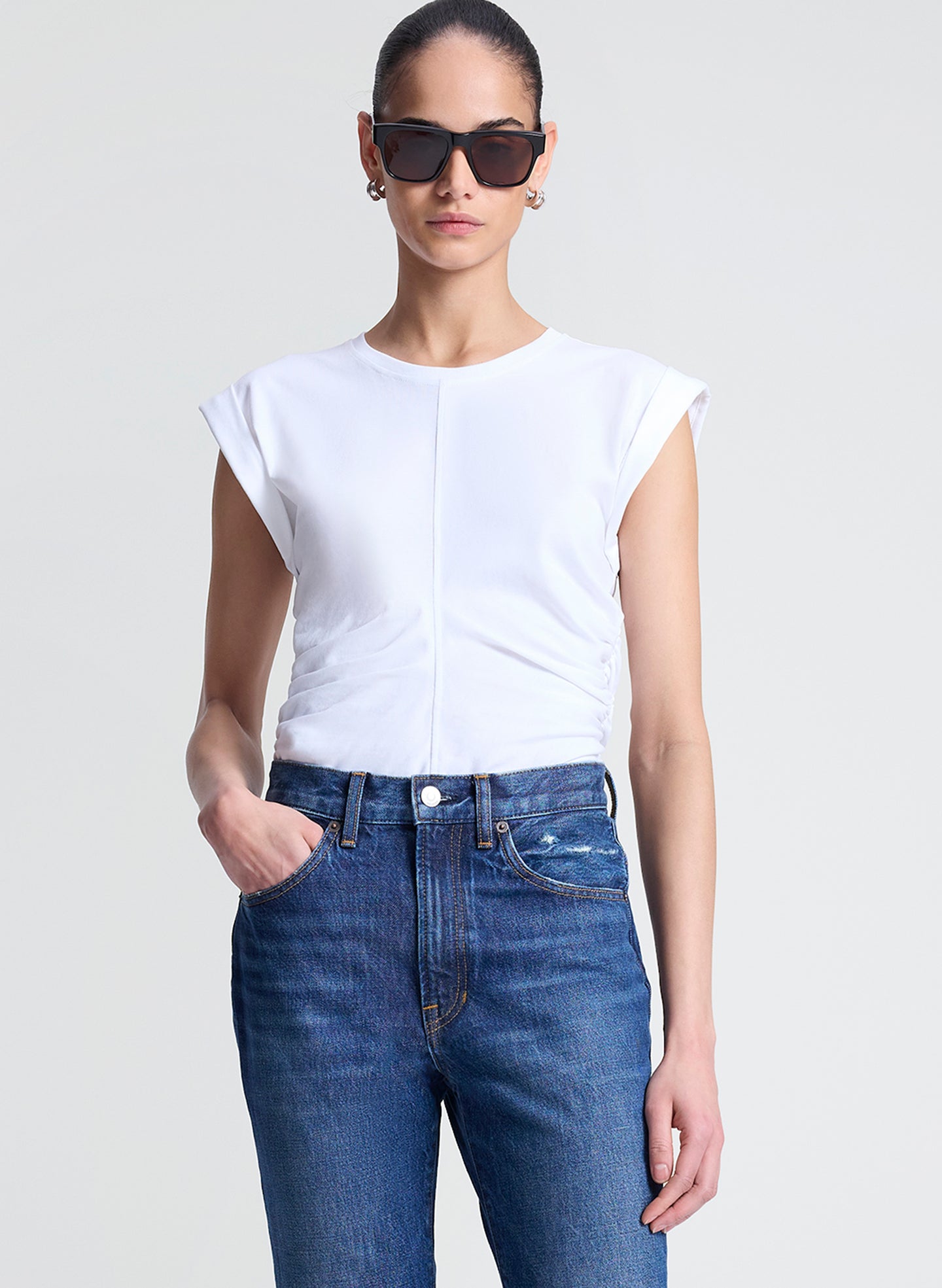 woman wearing white tshirt and medium blue wash denim jeans