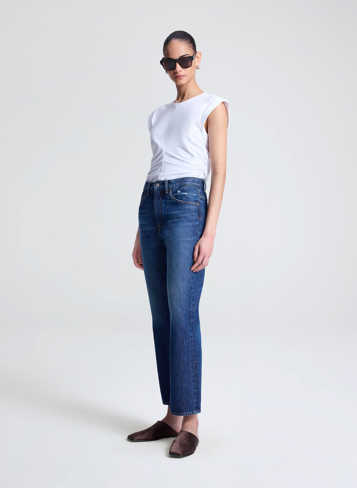 woman wearing white tshirt and medium blue wash denim jeans