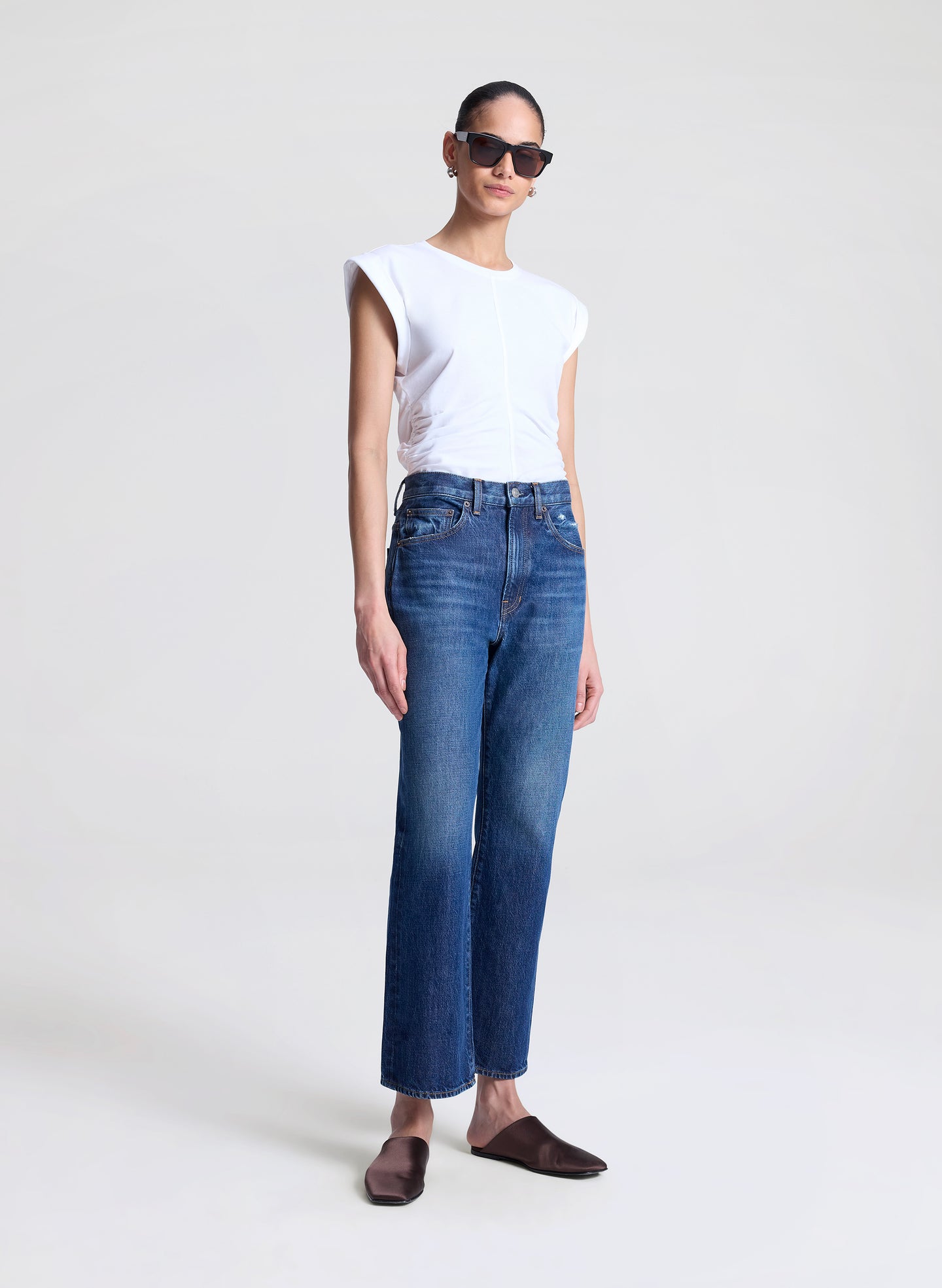 woman wearing white tshirt and medium blue wash denim jeans