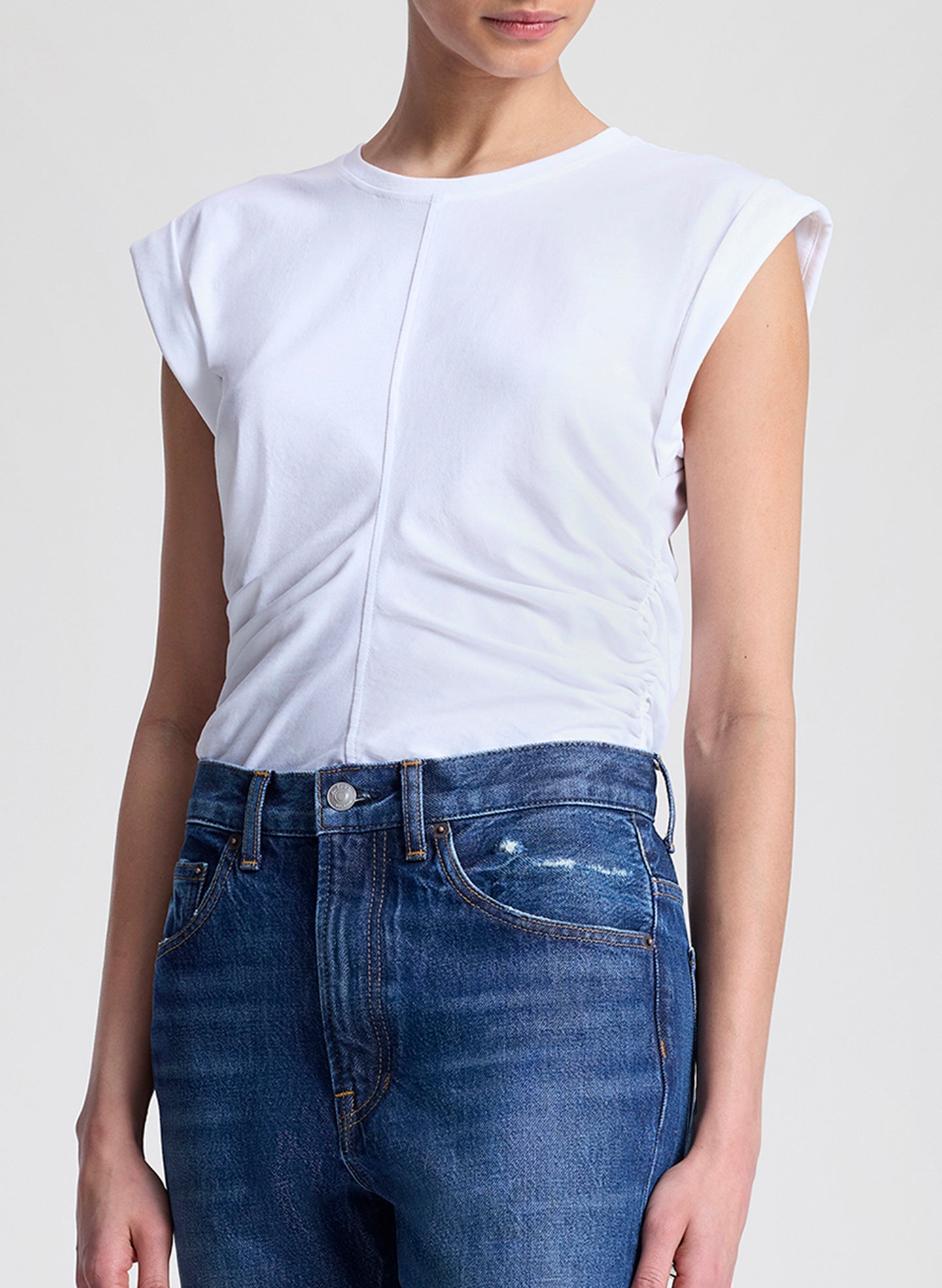 woman wearing white tshirt and medium blue wash denim jeans