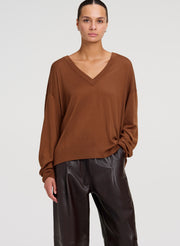 woman wearing brown sweater and brown leather pants