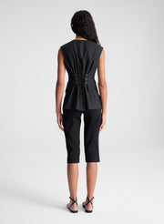 woman wearing black vest and black capri pants