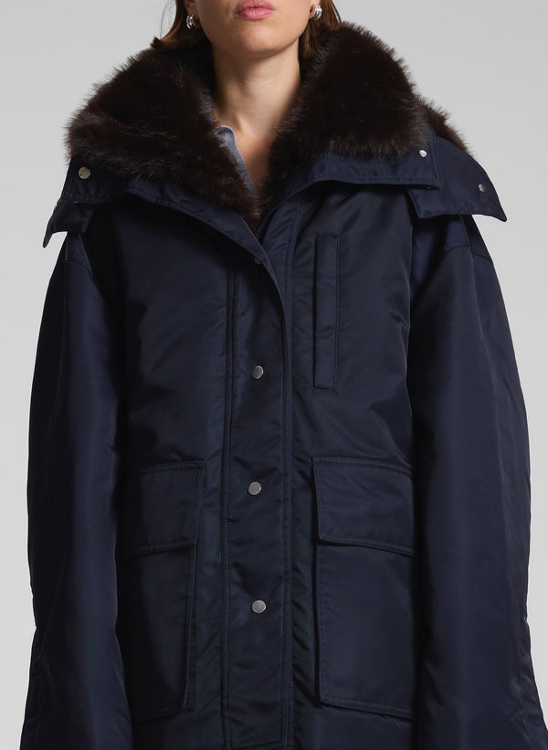 woman wearing navy blue faux fur lined coat