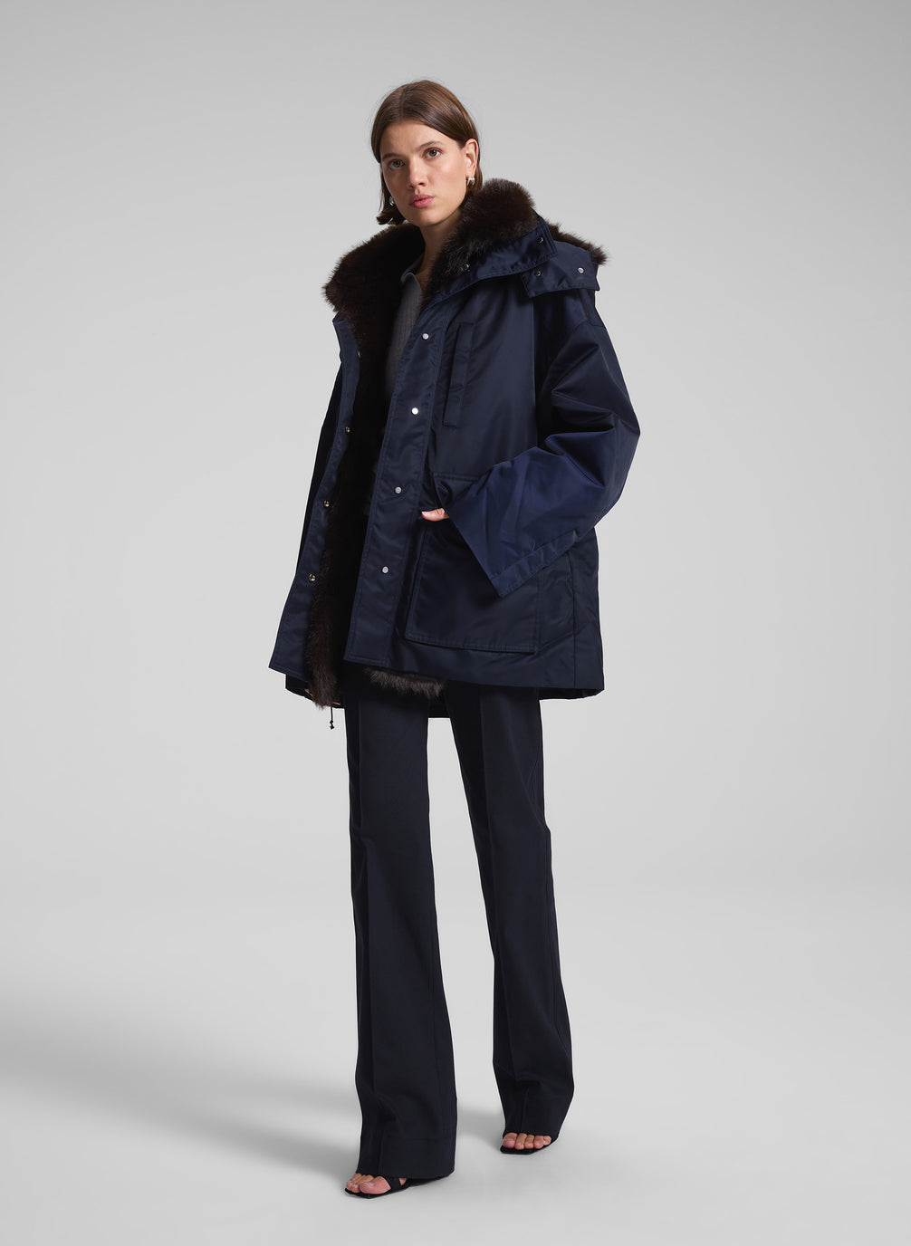 woman wearing navy blue faux fur lined coat