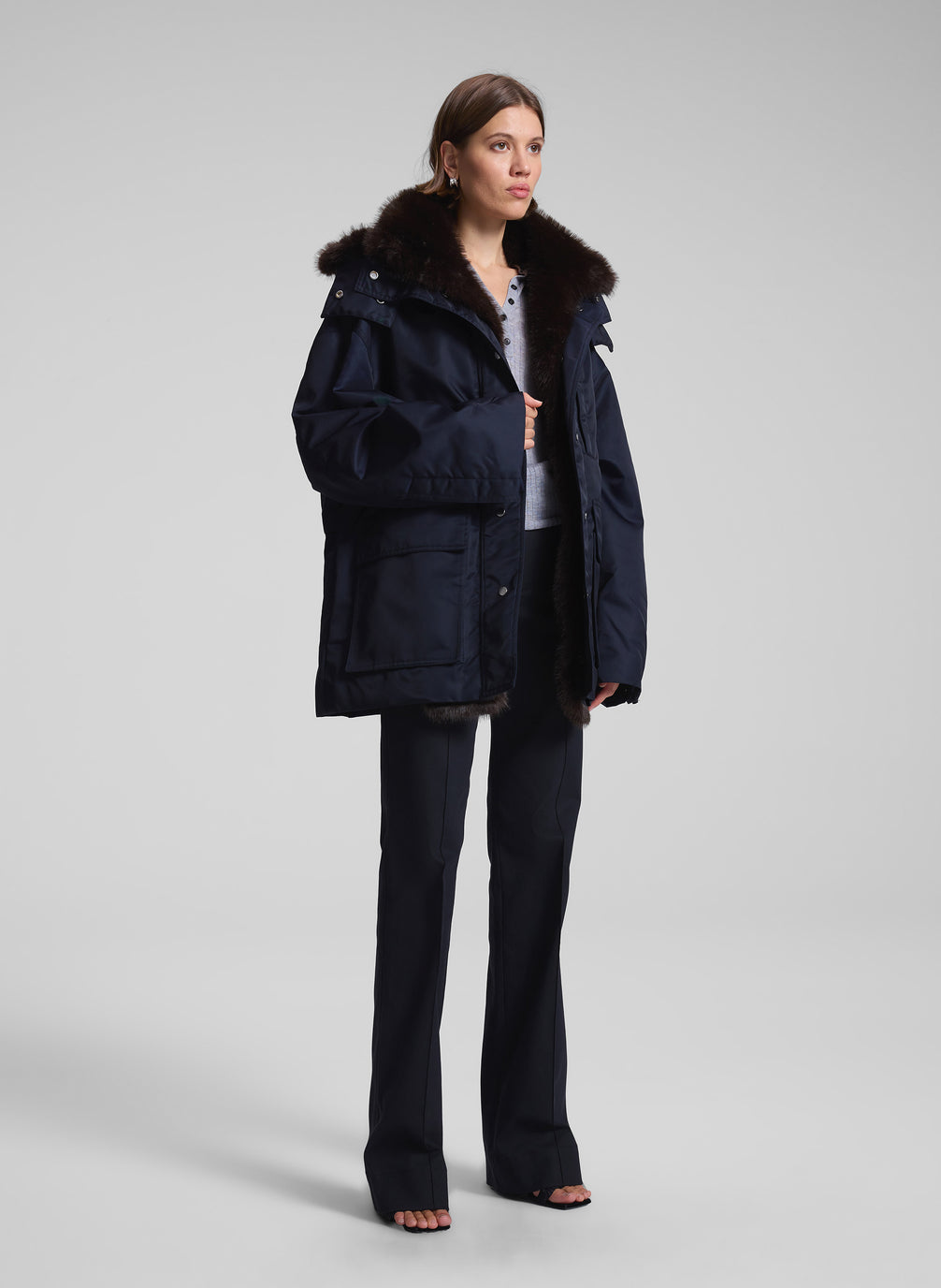 woman wearing navy blue faux fur lined coat