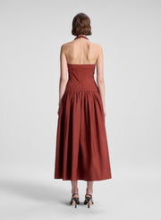 woman wearing maroon drop waist midi dress