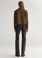 woman wearing olive green shirt and black denim jeans