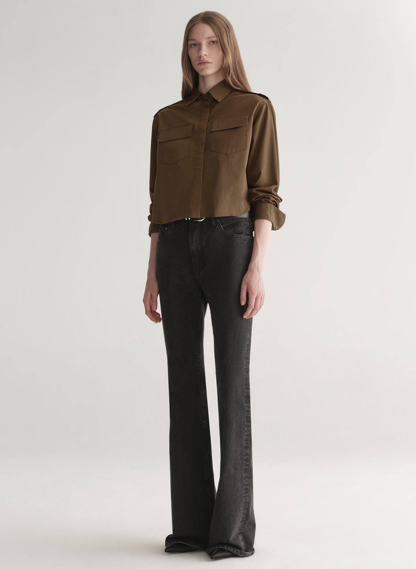 woman wearing olive green shirt and black denim jeans