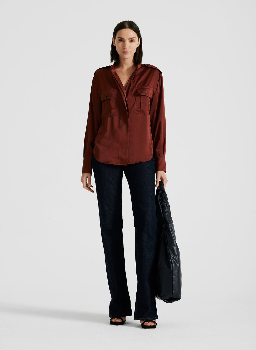 front view of woman wearing maroon satin long sleeve top and black pants