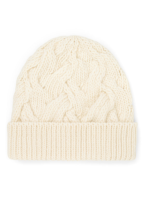 flat lay view of woman wearing cream cable knit beanie