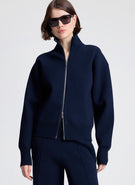 woman wearing navy blue zip cardigan and matching navy blue pants