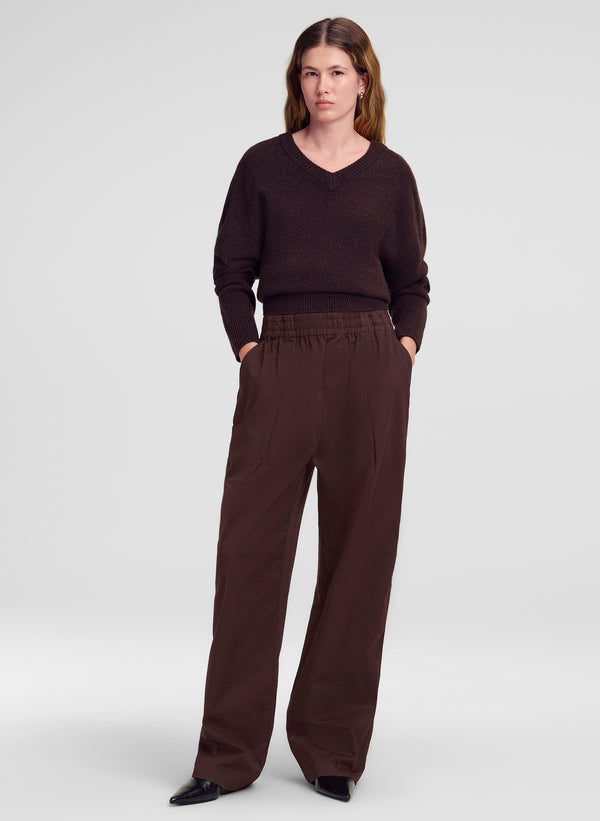 woman wearing brown sweater and brown pants