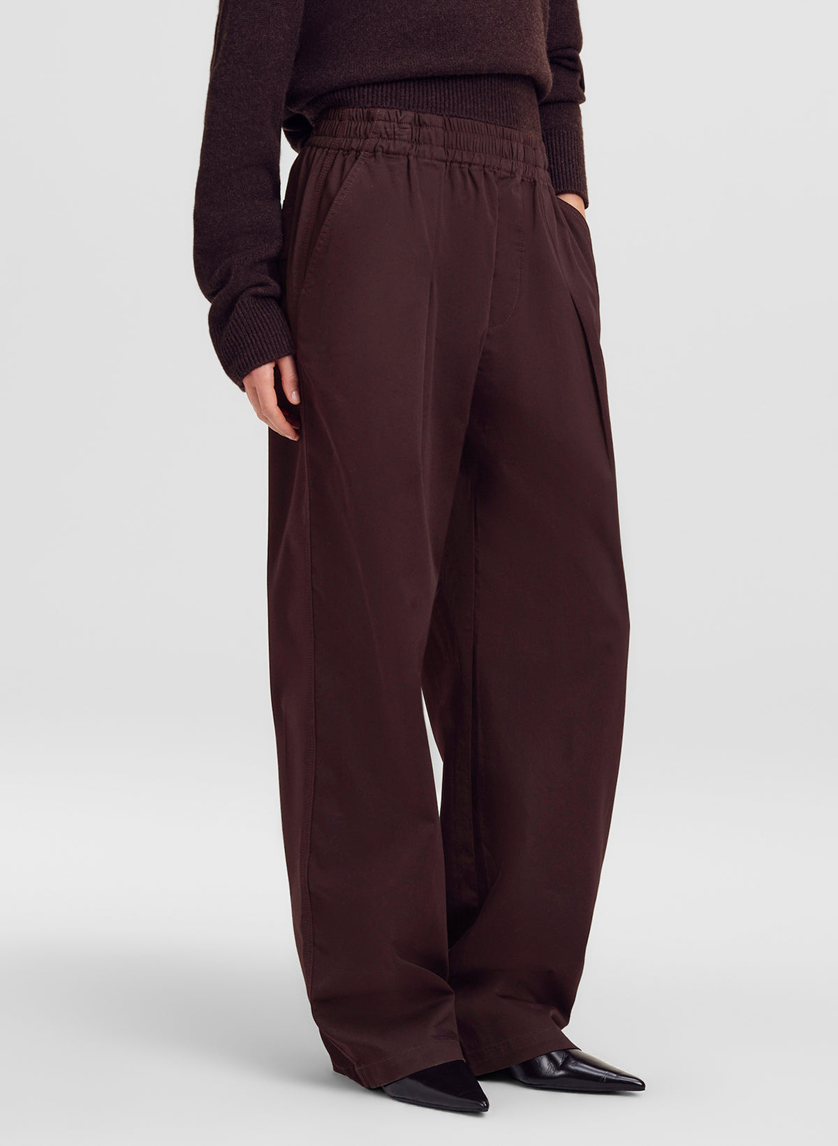 woman wearing brown pants, from waist down