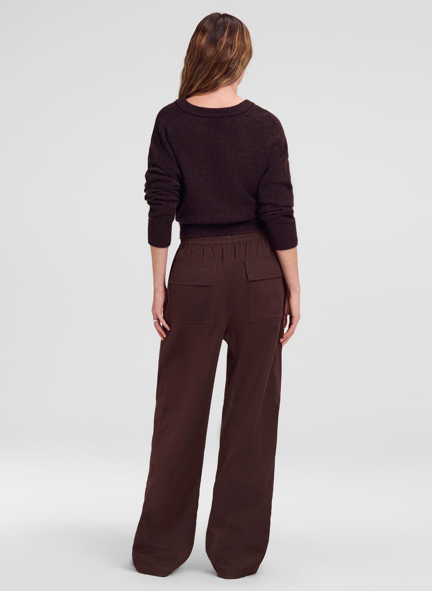woman wearing brown sweater and brown pants
